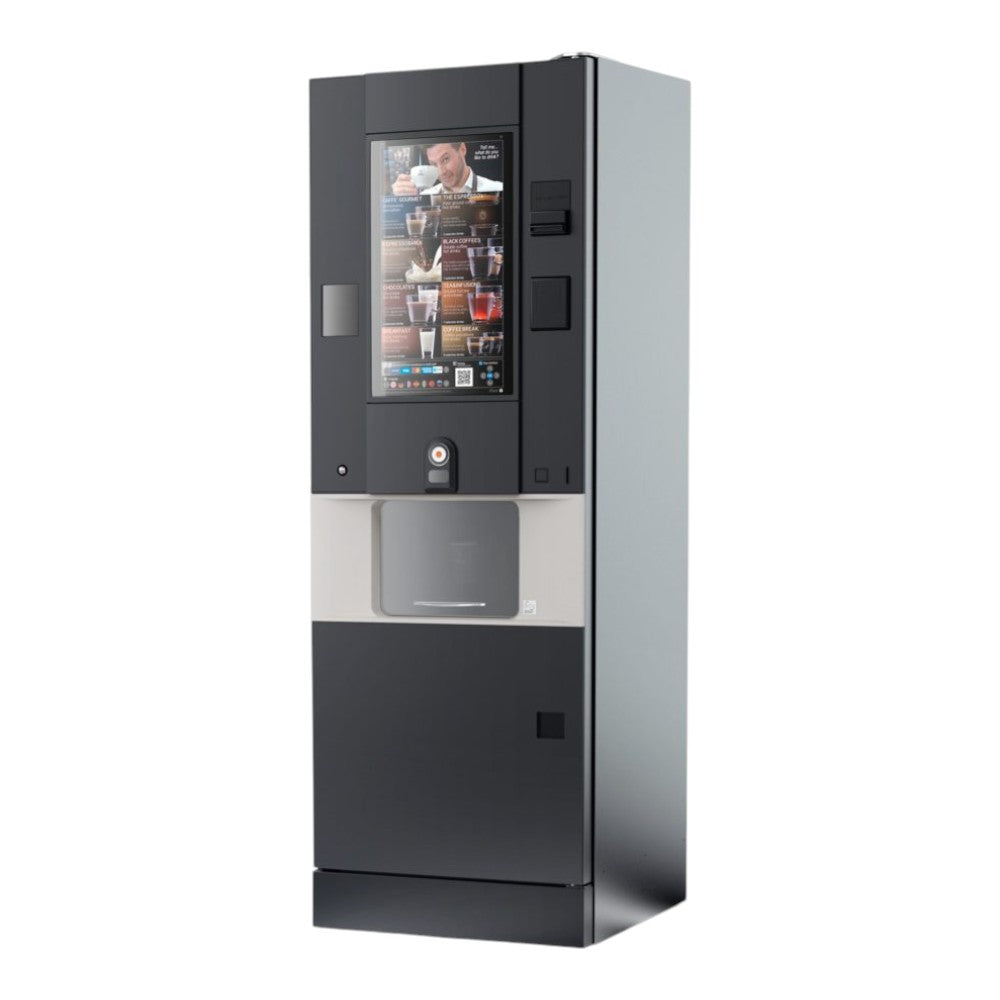 Een moderne Rhea Vendors rhFS1.touch vrijstaande koffieautomaat met groot touchscreen en een breed uitgiftegedeelte, geplaatst in de ontmoetingsruimte voor het bereiden van diverse warme en koude koffiespecialiteiten.
